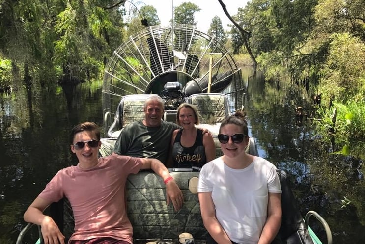 Family of four touring the Everglades on an airboat